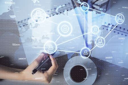 Social network theme hologram over hands taking notes background. Concept of global international people connect. Double exposureの写真素材