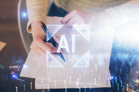 Double exposure of writing hand on background with data solution technology hologram. Ai concept.の写真素材