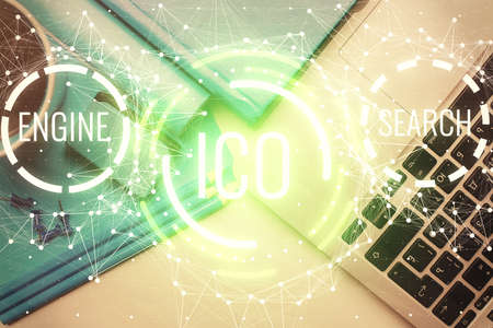 Blockchain theme hologram drawings over computer on the desktop background. Top view. Multi...