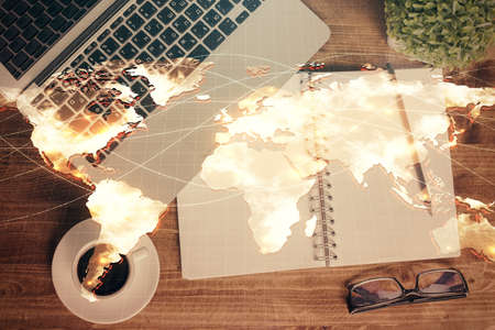 Business theme hologram drawings over computer on the desktop background. Top view. Multi exposure....