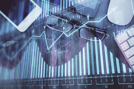 Multi exposure of forex graph hologram over desktop with phone. Top view. Mobile trade platform...