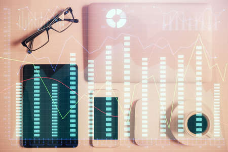 Multi exposure of financial chart hologram over desktop with phone. Top view. Mobile trade platform...