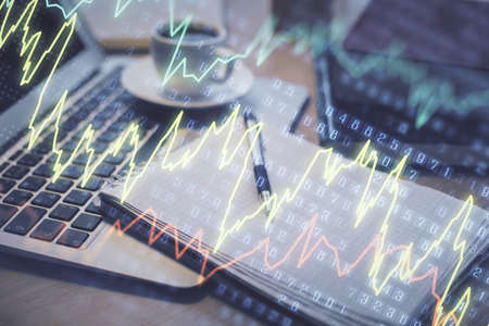 Double exposure of forex chart drawing and desktop with coffee and items on table background....