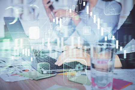 Multi exposure of woman hands typing on computer and forex chart hologram drawing. Stock market...