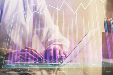 Double exposure of woman hands typing on computer and forex chart hologram drawing. Stock market...