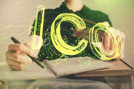 Double exposure of man hands holding a credit card and crypto business theme drawing. Digital...
