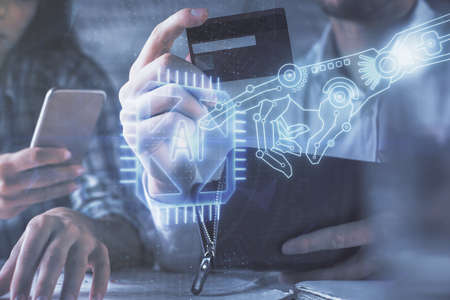 Double exposure of man and woman on-line shopping holding a credit card and data theme hologram...
