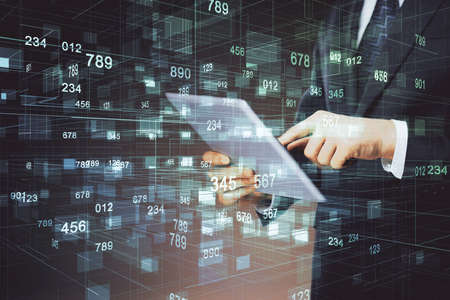 Double exposure of man's hand holding and using a digital device and data theme hologram drawing. Technology concept.の写真素材