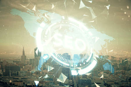 SEO hologram on city view with skyscrapers background double exposure. Search optimization concept.