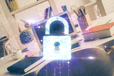 Double exposure of desktop with computer and lock icon hologram. Concept of data safety.の写真素材