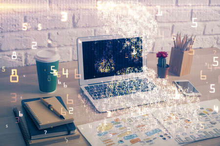 Computer on desktop in office with technology theme hologram. Double exposure. Tech concept.の写真素材
