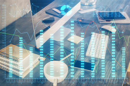 Double exposure of forex graph and work space with computer. Concept of international online...