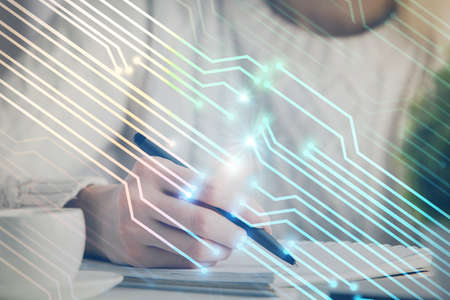 Multi exposure of writing hands on background with data solution hologram. Technology concept.