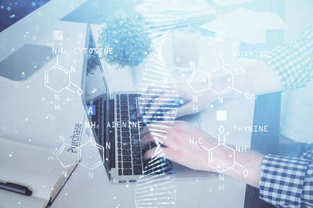 DNA hologram with businessman working on computer on background. Concept of bioengineering. Double...