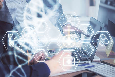 DNA hologram with businessman working on computer on background. Concept of bioengineering. Double...