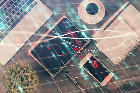 Double exposure of forex chart hologram over desktop with phone. Top view. Mobile trade platform...