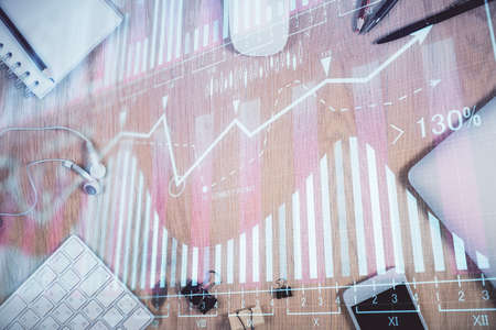 Multi exposure of forex graph hologram over desktop with phone. Top view. Mobile trade platform...
