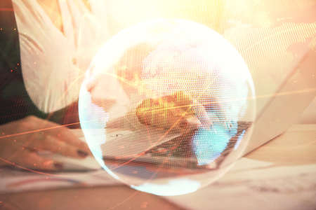 Multi exposure of woman hands typing on computer and business theme hologram drawing. Success concept.の写真素材