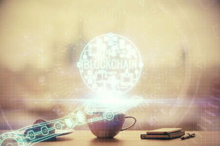 Double exposure of crypto currency theme drawing hologram over coffee cup background in office....