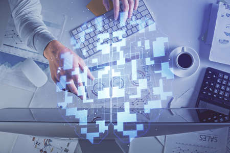 Double exposure of mans hands typing over computer keyboard and data theme hologram drawing. Top...