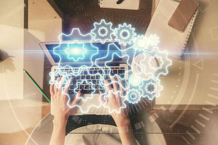 Double exposure of woman hands working on computer and financial theme hologram drawing. Top View....
