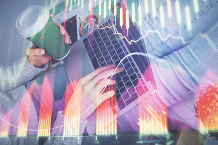 Double exposure of woman hands typing on computer and forex chart hologram drawing. Stock market...