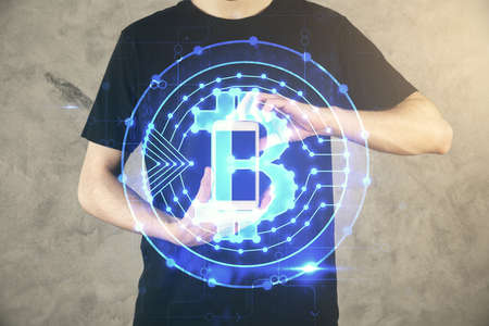Double exposure of mans hands holding and using a phone and crypto currency blockchain theme...