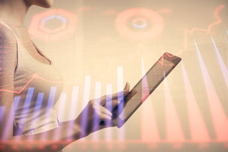 Double exposure of forex chart sketch hologram and woman holding and using a mobile device....