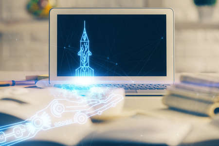 Desktop computer background in office and start up theme hologram drawing. Double exposure. Startup...