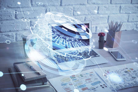 Double exposure of desktop computer and technology theme hologram. Concept of software development.