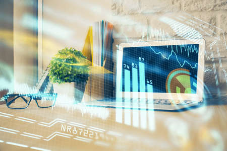 Computer on desktop in office with technology theme hologram. Multi exposure. Tech concept.