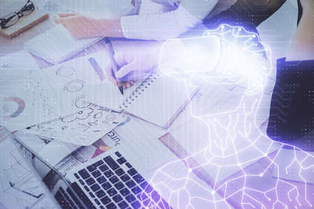 AR hologram over hands taking notes background. Concept of augmented reality. Double exposure
