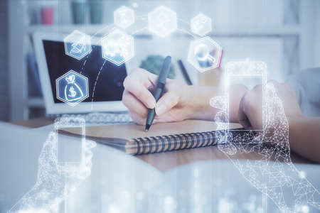 Tech theme hologram over womans hands taking notes background. Concept of hightech. Double exposure