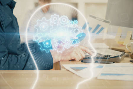 Man with computer background with brain theme hologram. Concept of brainstorm. Double exposure.