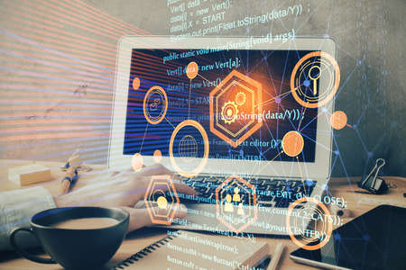 Double exposure of data internet theme hologram with man working on computer on background. Concept...