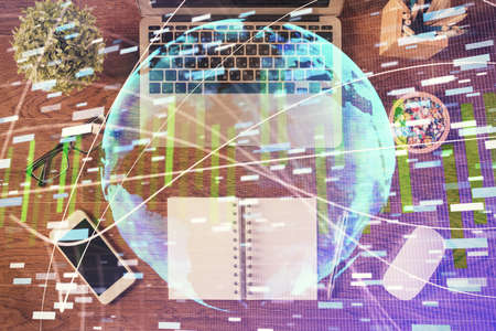 Business theme hologram drawings over computer on the desktop background. Top view. Multi exposure. Concept of international connections.の写真素材