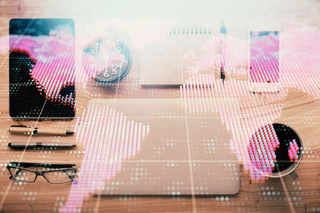 Double exposure of business theme hologram over desktop with phone. Top view. Mobile international trade connection concept.の写真素材