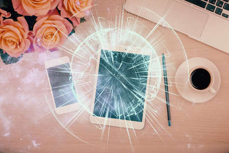 Double exposure of business theme hologram over desktop with phone. Top view. Mobile international trade connection concept.の写真素材