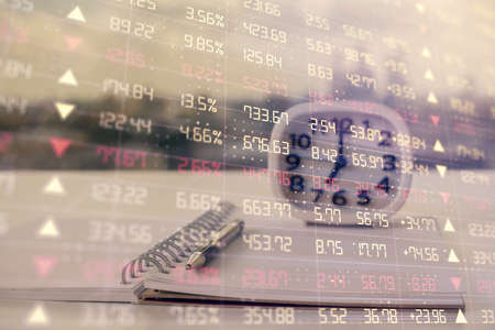 Double exposure of financial graph drawings and desk with open notebook background. Concept of forex...