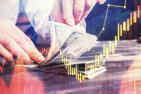 Multi exposure of forex graph drawing hologram and USA dollars bills and man hands. Technical...