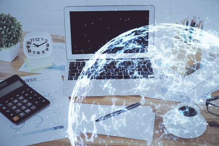 Computer on desktop with social network hologram. Double exposure. Concept of international people connections.の写真素材