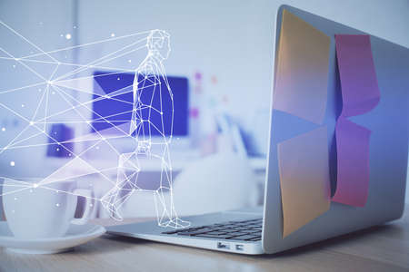 Desktop computer background in office and start up theme hologram drawing. Double exposure. Startup concept.の写真素材