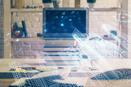 Desktop computer background in office and big town buildings hologram drawing. Double exposure....