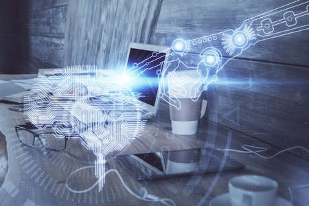 Multi exposure of work table with computer and brain hologram. Brainstorm concept.