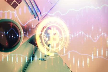 Blockchain theme hologram drawings over computer on the desktop background. Top view. Multi exposure. Concept of cryptoeconomy.の写真素材