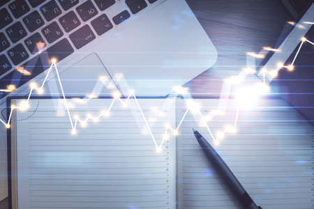 Stock market graph and top view computer on the table background. Multi exposure. Concept of...