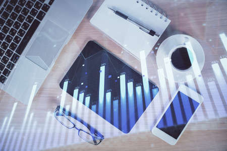 Multi exposure of forex graph hologram over desktop with phone. Top view. Mobile trade platform concept.の写真素材