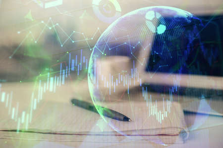 Double exposure of financial graph drawings and desk with open notebook background. Concept of forex marketの写真素材
