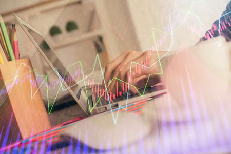 Double exposure of woman hands typing on computer and forex chart hologram drawing. Stock market...