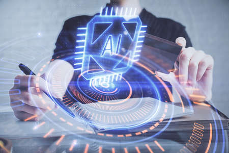 Double exposure of man hands holding a credit card and data theme drawing. E-commerce and technology concept.の写真素材